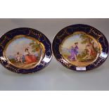 A pair of 19th century Vienna style cabinet plates, each painted to the well with a Classical