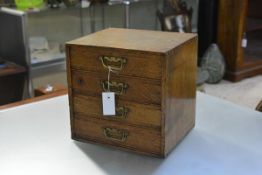 A 19th century small oak collector's chest, of four graduated drawers, one fitted with a lock.