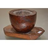 A large 19th century burr elm and elm mortar on stand, the burr mortar with inset rim, raised on a