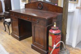 A William IV mahogany sideboard, the pedimented backboard carved in relief with a laurel wreath,