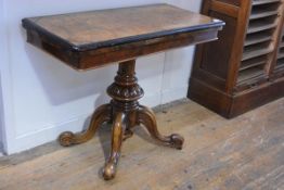 A mid-Victorian burr walnut foldover tea table, the top with ebonised rim over a plain frieze and