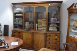 A William IV mahogany breakfront bookcase, 1830's, the upper section with moulded cornice above