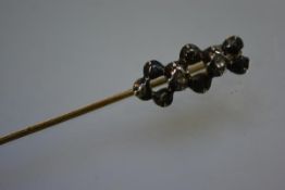 A late 19th century stick pin, set with two old-cut diamonds, cased.