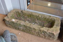 A long rectangular weathered stone garden trough planter. 20cm by 90cm by 35cm