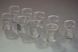 A set of nine Lalique glass liqueur or shot glasses in the Enfants pattern, etched mark "Lalique