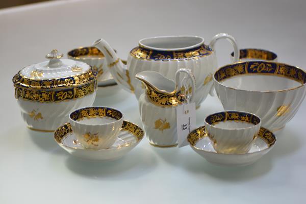 An English porcelain partial tea service, c. 1800, possibly Caughley, each piece of wrythen form,