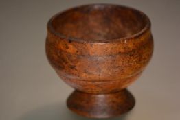 Treen: a 19th century burr elm pedestal bowl, of circular form on a domed foot. Diameter 14cm