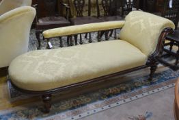 A mid-Victorian walnut-framed chaise longue, with boldly carved foliate scroll end and galleried