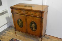 A Sheraton Revival painted satinwood side cabinet, early 20th century, the rectangular top centred