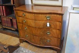 A George III satinwood crossbanded mahogany chest of drawers, of serpentine form, with four long