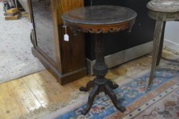 A Continental parquetry tripod table, 19th century, with chessboard circular top above a scroll-