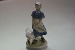 A Royal Copenhagen porcelain figure of a goose girl, model no. 527. 24cm