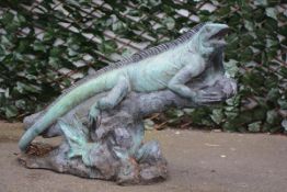 A patinated bronze garden sculpture of an Iguana, signed indistinctly and dated 2003, modelled