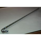 A glass cane of Nailsea type, with coloured overlay and airtwist decoration. Length 107cm