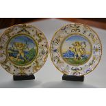 A pair of Cantagalli maiolica plates, c. 1900, of Urbino type, each painted to the well with a putto