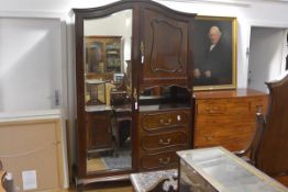 An Edwardian mahogany four piece bedroom suite, comprising mirror-fronted wardrobe, dressing table