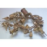 A gold charm bracelet, the curblink chain stamped 15ct, suspending a variety of 9ct gold charms