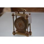 A gilt-brass mantel clock, c. 1900 the drumhead dial enclosing a silvered chapter ring with Arabic