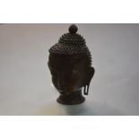 A bronze head of Buddha, probably Thai, 20th century. 21.5cm