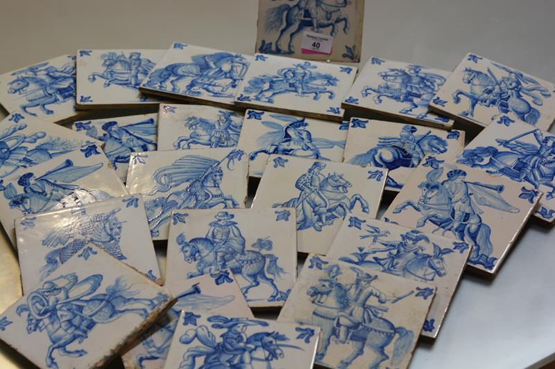 A set of twenty-four Delft blue and white hand painted tiles, depicting mounted figures in