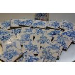 A set of twenty-four Delft blue and white hand painted tiles, depicting mounted figures in
