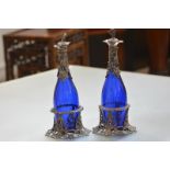 A pair of 19th century white metal mounted "Bristol" blue glass bottle decanters, each with grapes