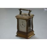 A French gilt-brass repeating carriage clock, c. 1900, the white enamel dial with Roman numerals