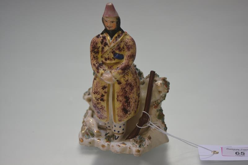 A rare early 19th century Staffordshire figure of a Turkish huntsman, modelled standing, with a