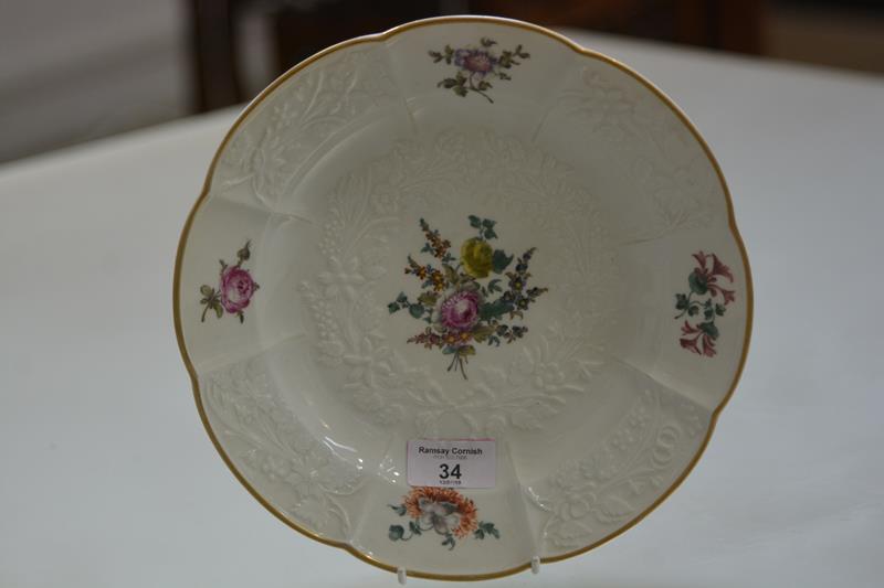 A Meissen dish, 19th century, with gilt scalloped rim the well and rim moulded and painted with
