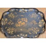 A good gilt-decorated papier mache tray, late 19th century, of cartouche form, finely painted with