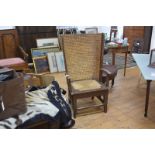 An early 20th century Orkney chair, the brown-painted pine frame enclosing a woven back above a