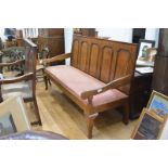 A George III oak settle, c. 1800, the back with moulded crest rail above five fielded shaped