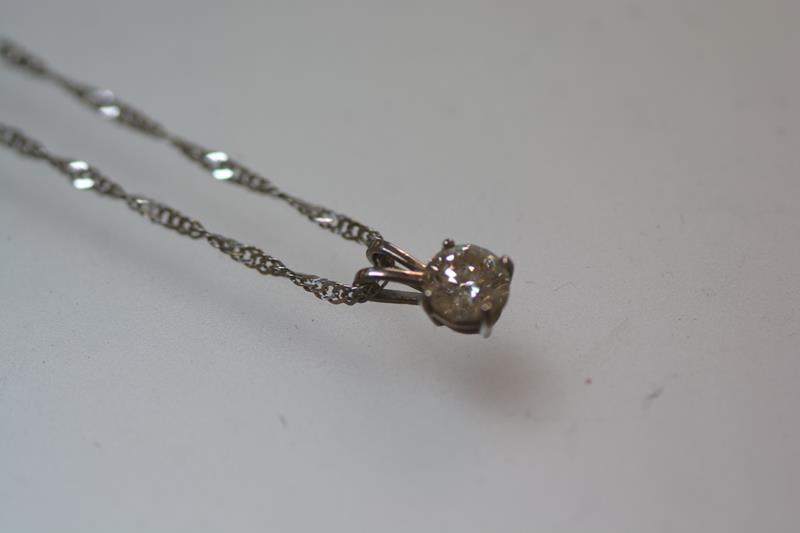 A diamond solitaire pendant, the round brilliant-cut stone weighing approximately 0.5 carats, claw