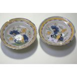 A pair of 18th century small Delft polychrome dishes, each painted with flowers and leaves with a