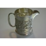 An Edwardian silver cream jug, Birmingham 1905, of cylindrical form, chased with a band of Art