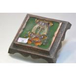 A copper and tile teapot stand, in the Art Nouveau taste, the tueblined tile decorated with