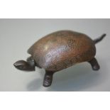 A German novelty lacquered bronze table bell, early 20th century, modelled as a turtle, the shell