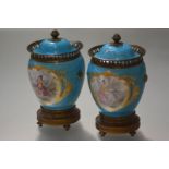 A pair of 19th century French gilt-metal mounted porcelain vases and covers, painted with gilt