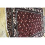 A Turkeman carpet, the central rectangle with stylised flowerhead motif enclosed within a leaf and