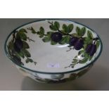 A Wemyss pottery wash bowl, painted in the purple plums pattern, impressed mark for Wemyss and