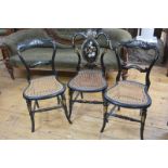 A group of three Victorian mother-of-pearl inlaid ebonised papier mache chairs, each with canework