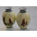 A pair of small Royal Crown Derby porcelain vases, of ribbed ovoid form, each painted with ships and