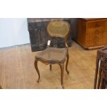 An Edwardian giltwood dressing table chair, in the French taste, the canework cartouche back above a