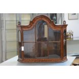 A Dutch marquetry walnut hanging vitrine or display cabinet, 19th century, the shaped arched cornice