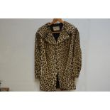 A 1940's leopard skin (Panther Pardus) short coat, with broad collar and flared sleeves, the