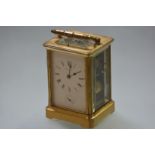 A gilt-brass repeating and alarm carriage clock, c. 1900, the white enamel dial with Roman