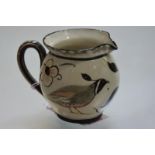 An unusual painted pottery jug designed by William Miles Johnston (1893-1974) decorated with