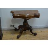 A mid-Victorian burr walnut foldover card table, the cartouche top with moulded edge opening and