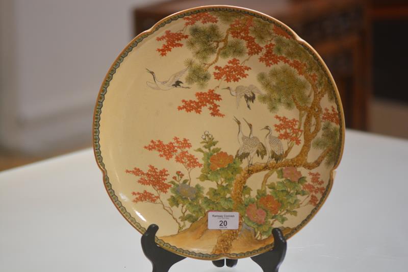 A Satsuma pottery plaque, early 20th century, of circular form with scalloped rim, painted with