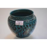 A turquoise glazed pottery vase, possibly Iranian, of baluster form decorated in black with stylised
